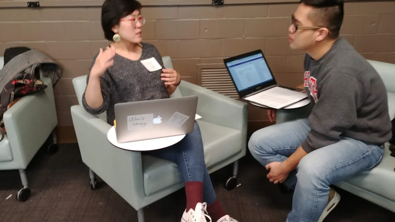 Two instructors discuss their teaching during the WAC Seminar